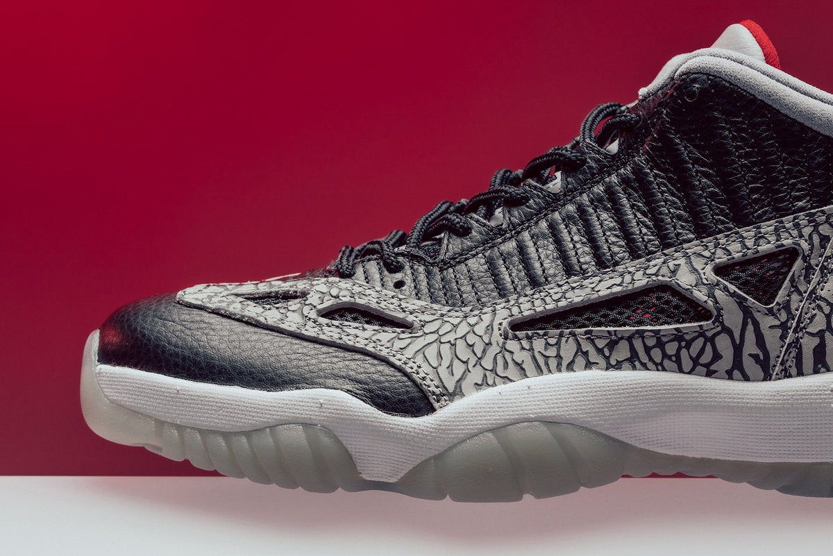 Air Jordan 11 Retro Low IE "Black Cement" - Black/Fire Red